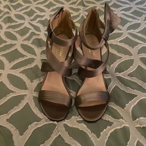 4 inch heels. Bronze with zipper in the back. Now on the side. Never been worn.